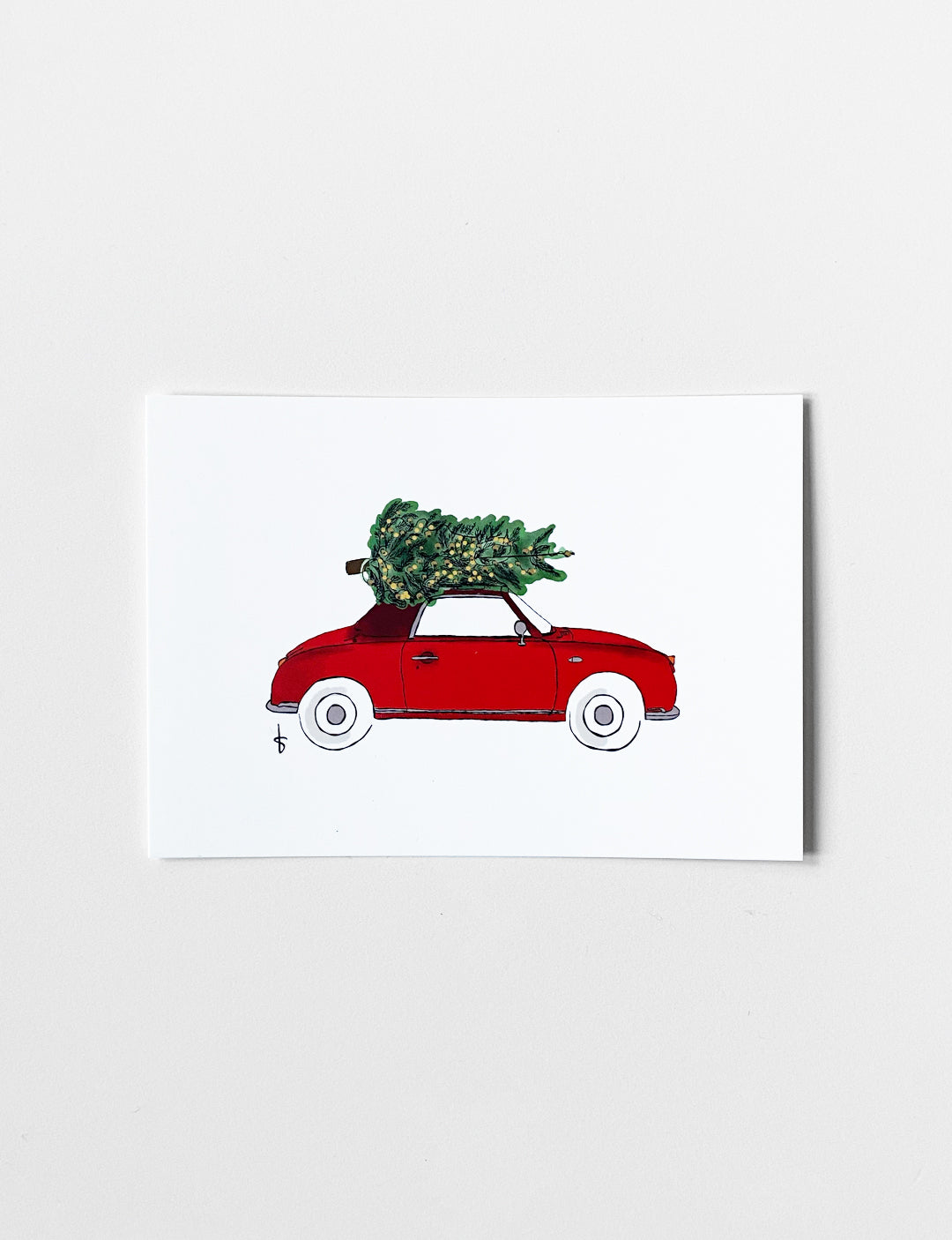 Ansichtkaart (A6) met handgetekende X-mas car illustratie in kersttinten en goudfolie. Deze kaart maakt onderdeel uit van een kaartenset met leuke kerstkaarten. Je kunt deze mooie kerstkaarten kopen in onze webshop.